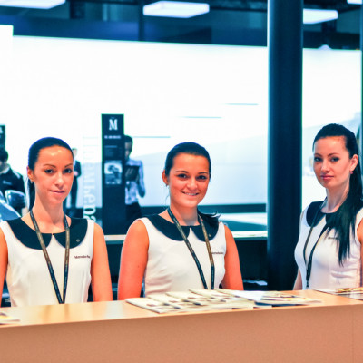 a group of women standing behind a counter