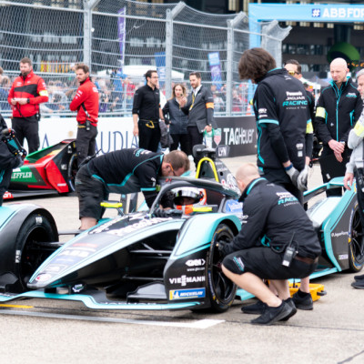 a group of people around a race car