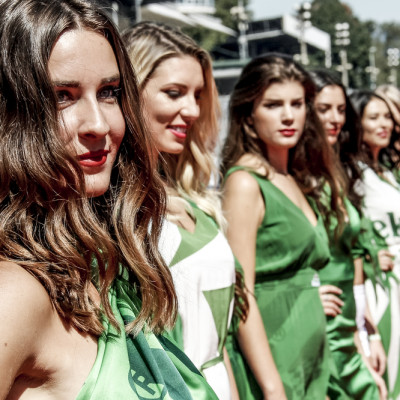 a group of women in green dresses